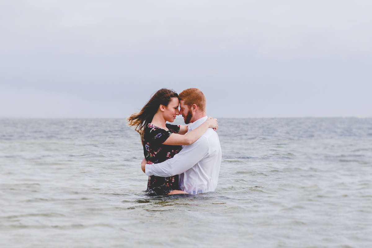 sitting, hugging, couple, ocean, storm, sky