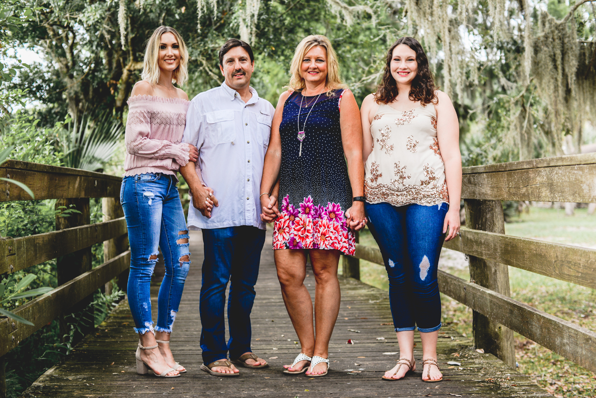 family, boardwalk, holding hands, trees, moss, park