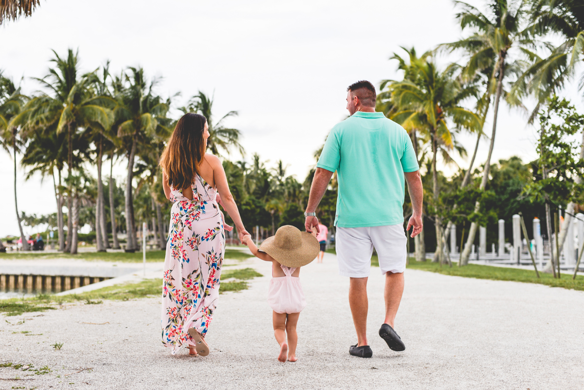 sun hat, walking, holding hands, beach, palm trees, family