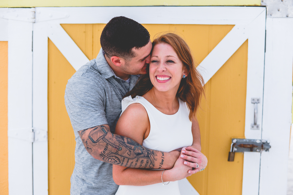 barn door, yellow, couple, laughing, tattoos 