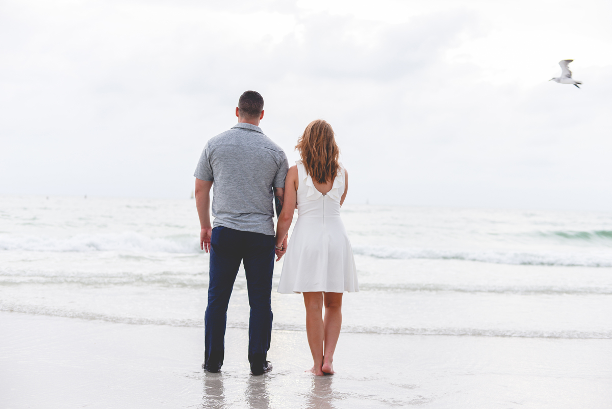 holding hands, seagull, waves, ocean, beach, horizon 