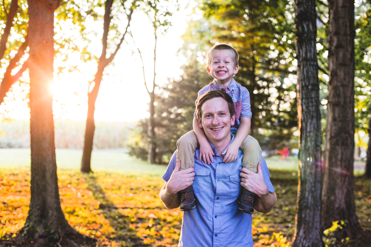 father, son, playing, sun flare, trees