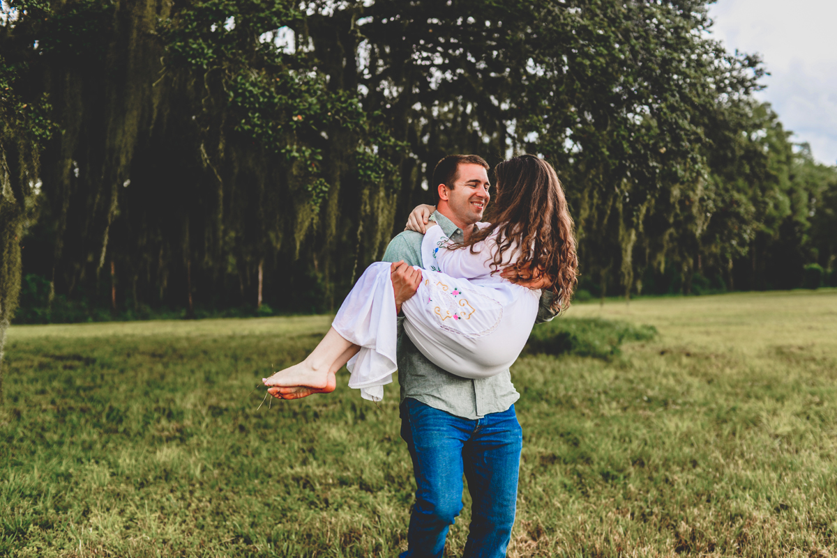 holding, grass, field, tress, barefoot 