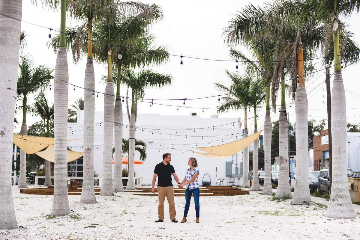 palm trees, holding hands, laughing, couple, beach, sand