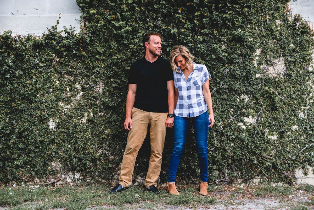 greenery, green wall, casual, laughing, holding hands