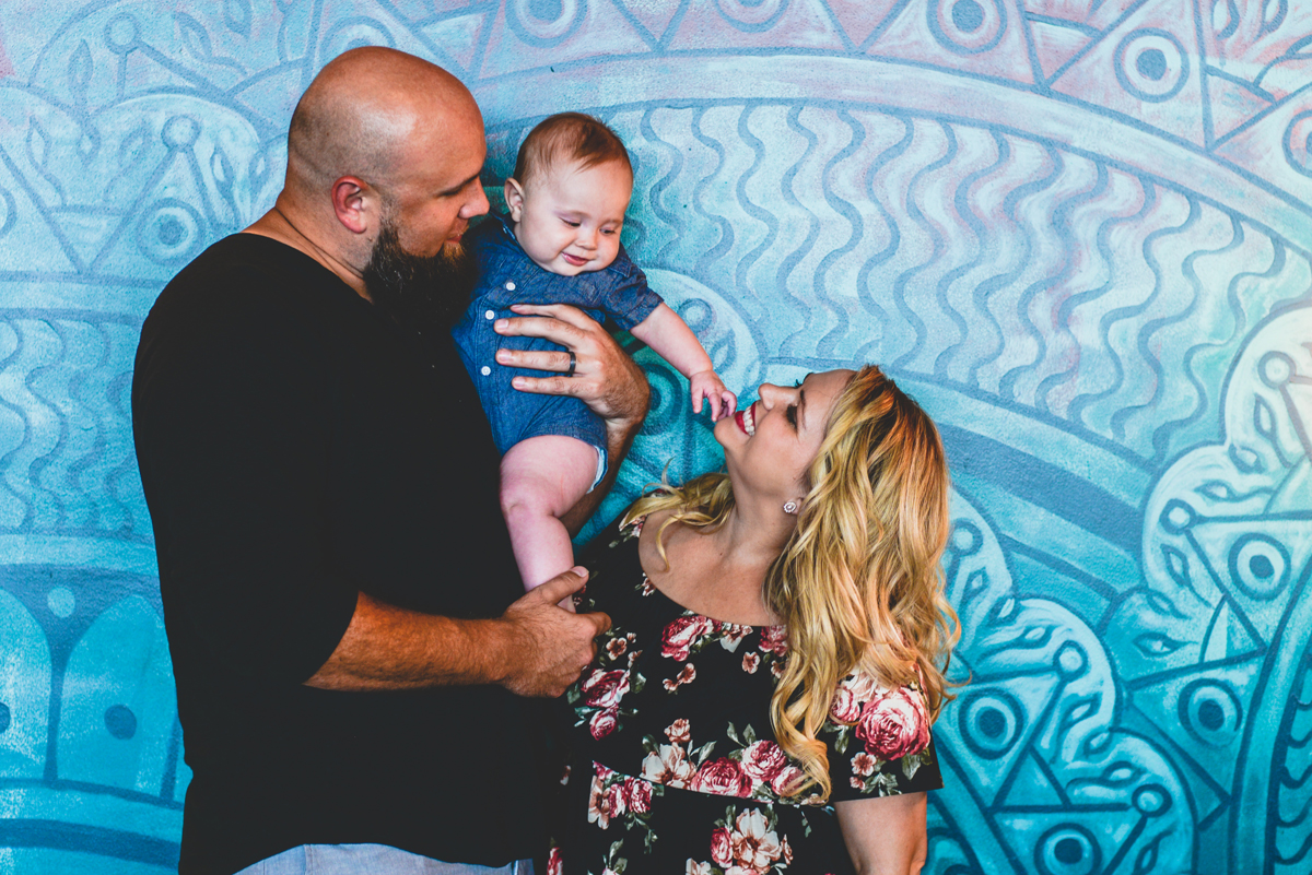 mom, dad, family, holding hands, mural, blue