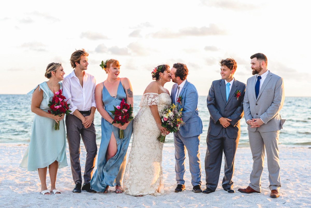 kissing, bridal party, beach, ocean, husband, wife