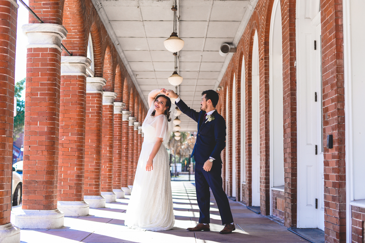 dancing, spinning, wedding dress, brick, columns, ybor