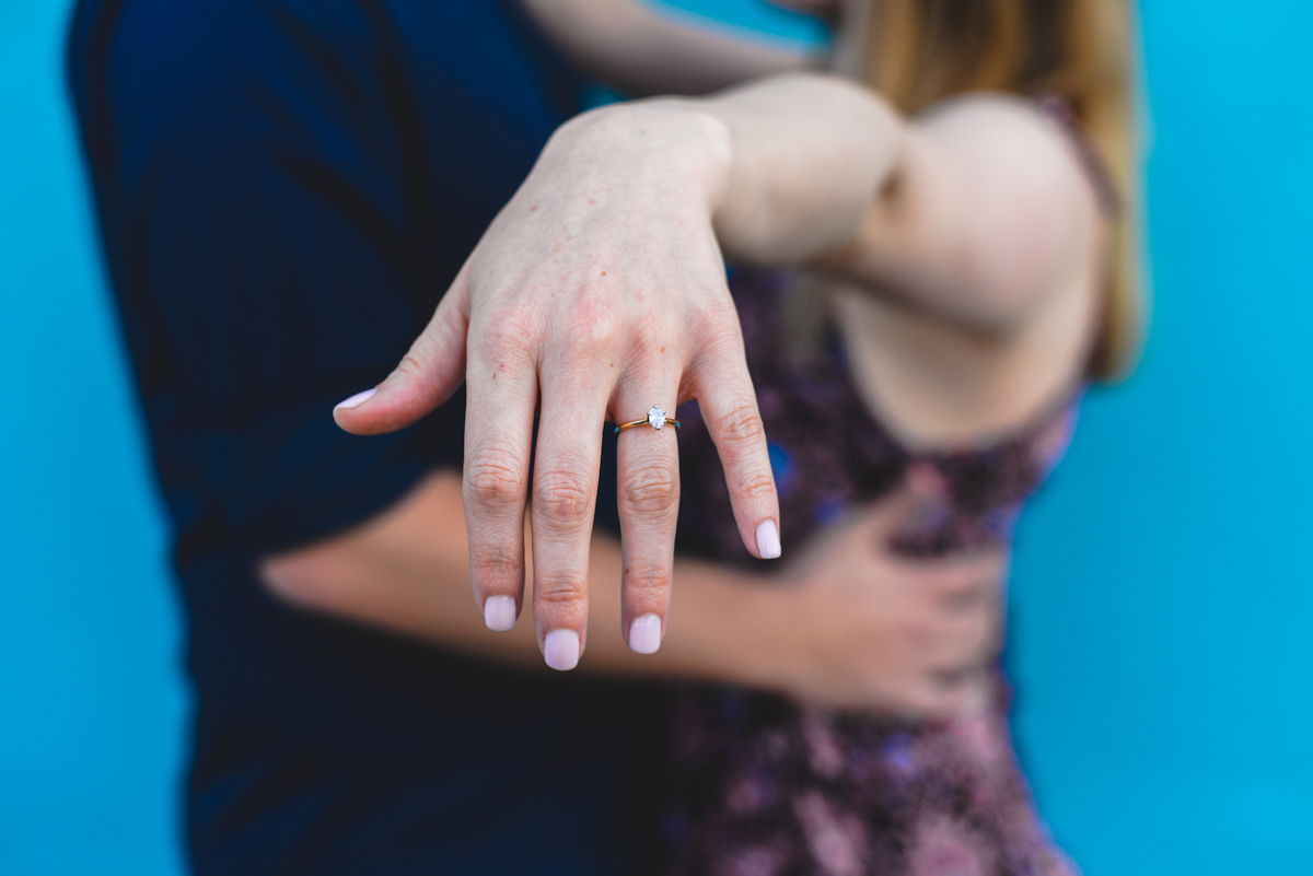 ring shot, diamond, detail, engaged, blue wall