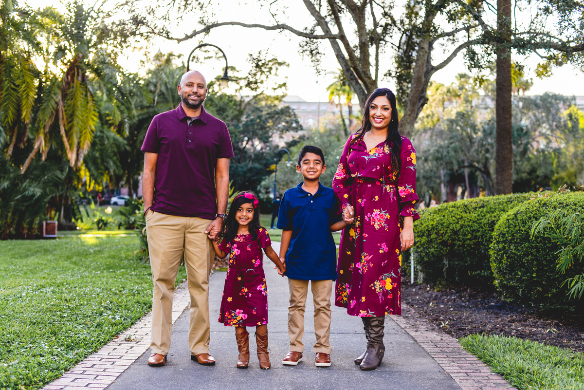 family, holding hands, UT, sidewalk, greenery