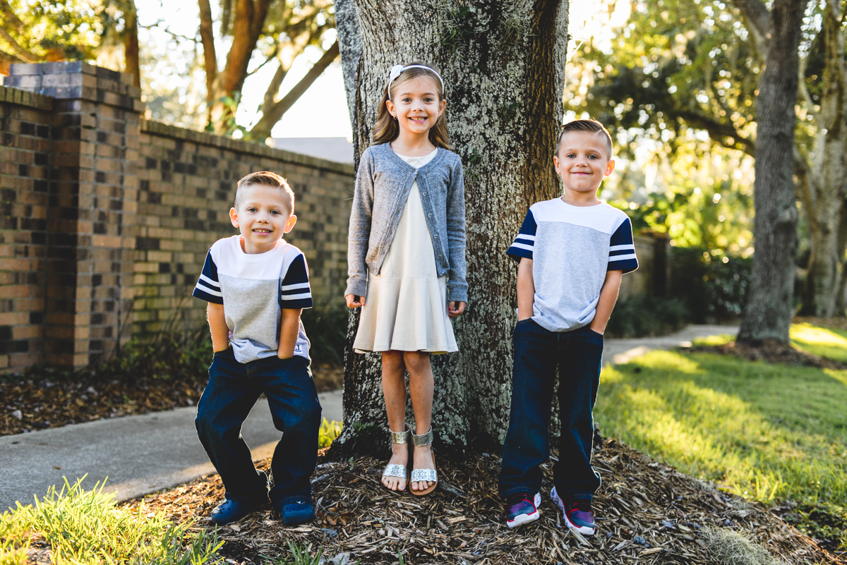 kids, family, siblings, brick, trees, sun, smiles