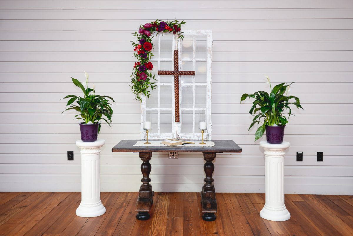 wedding, altar, cross, flowers, greenery 