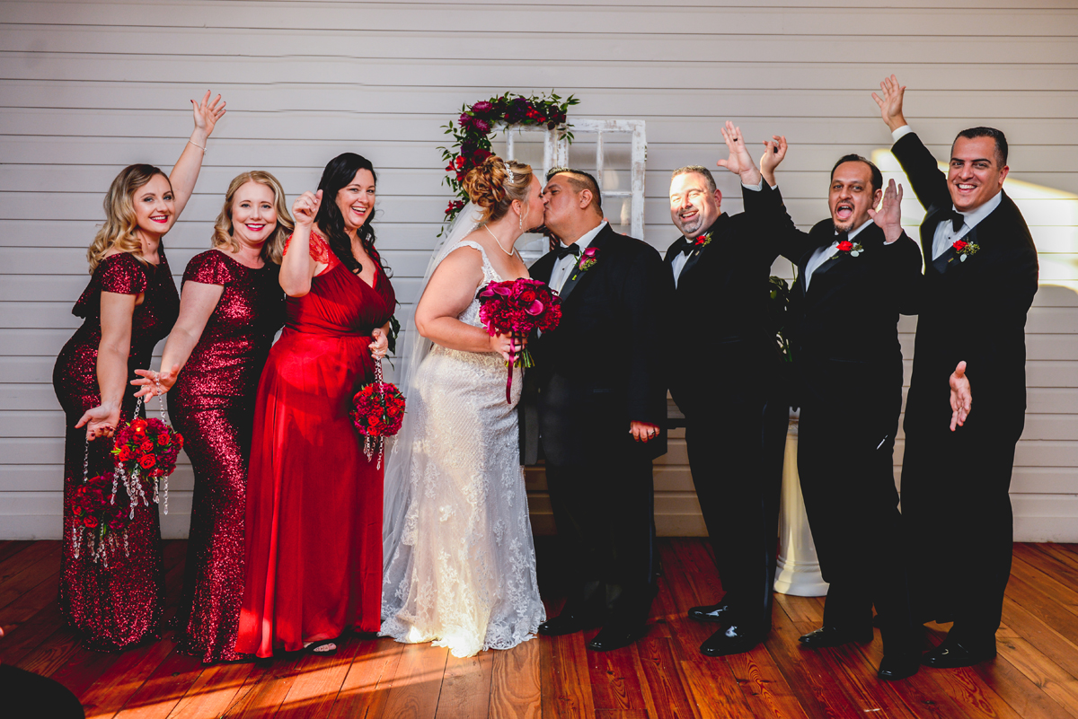 bridal party, cheering, bride, groom, red dress, black tux