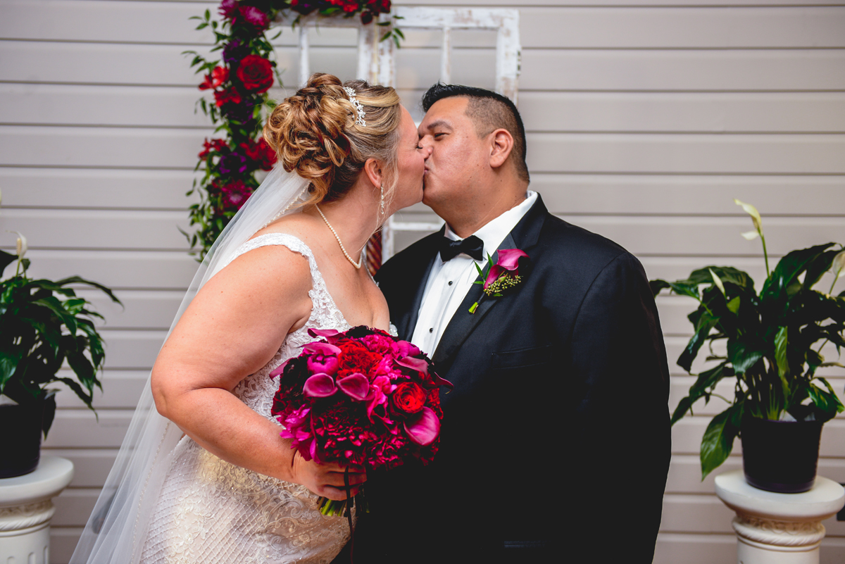 bride, groom, kissing, just married, pink, purple