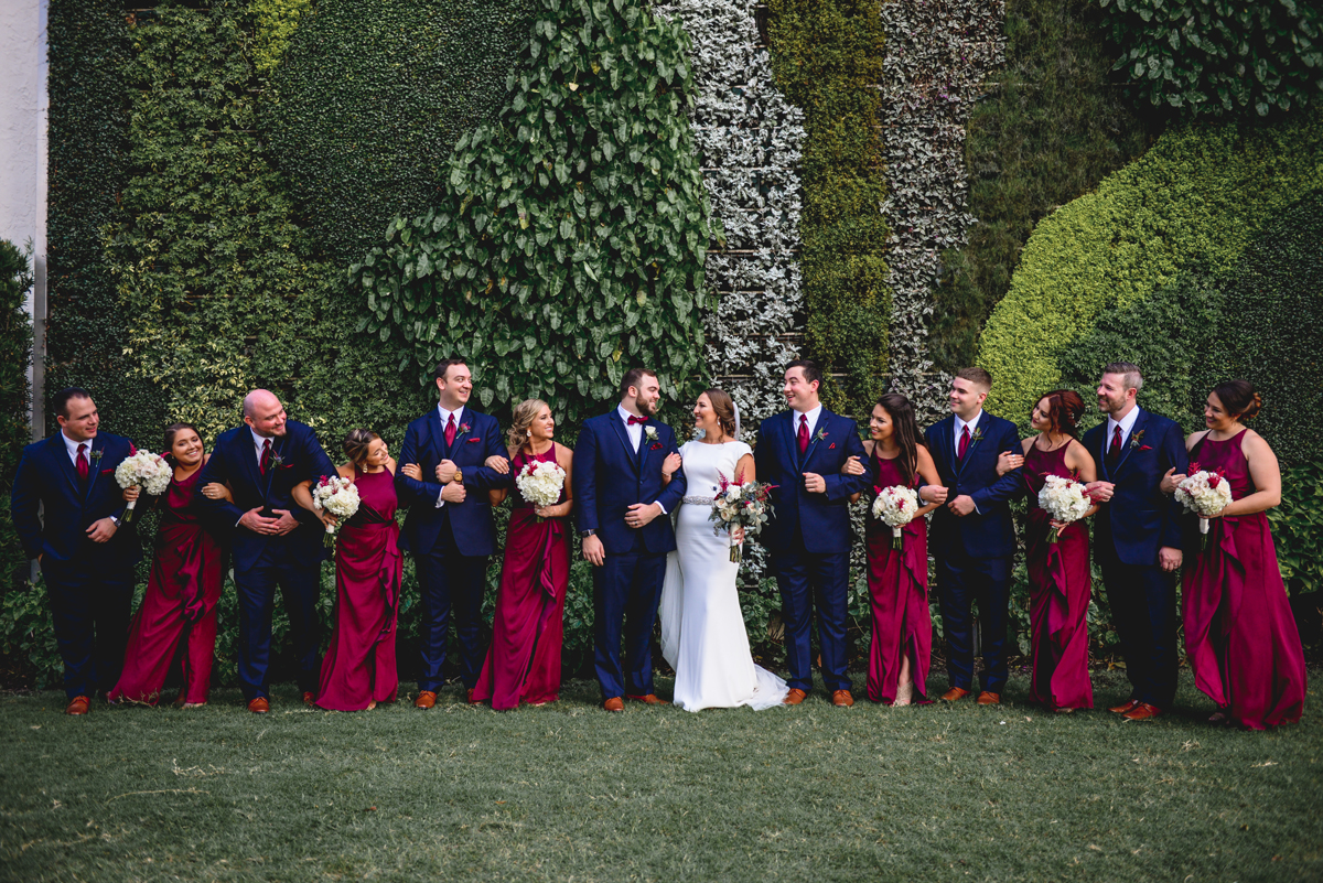 bridal party, greenery wall, husband, wife, friends