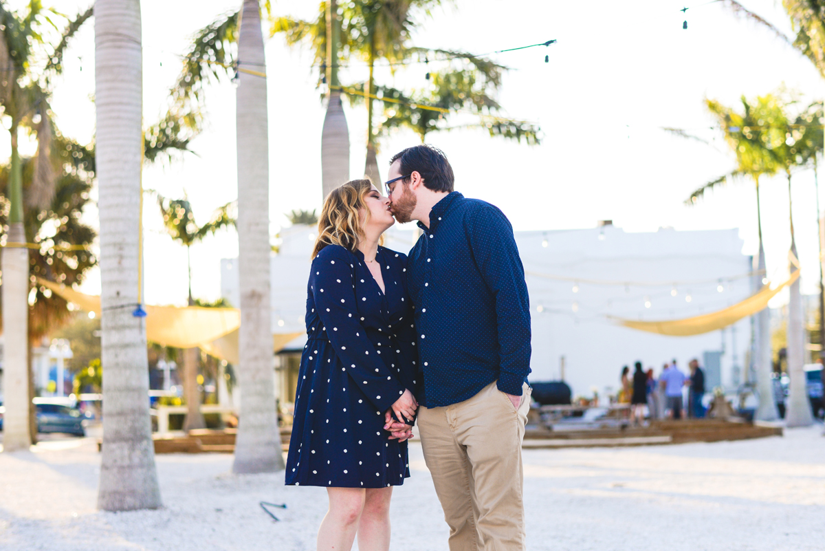 palm trees, string lights, kissing, couple, holding hands