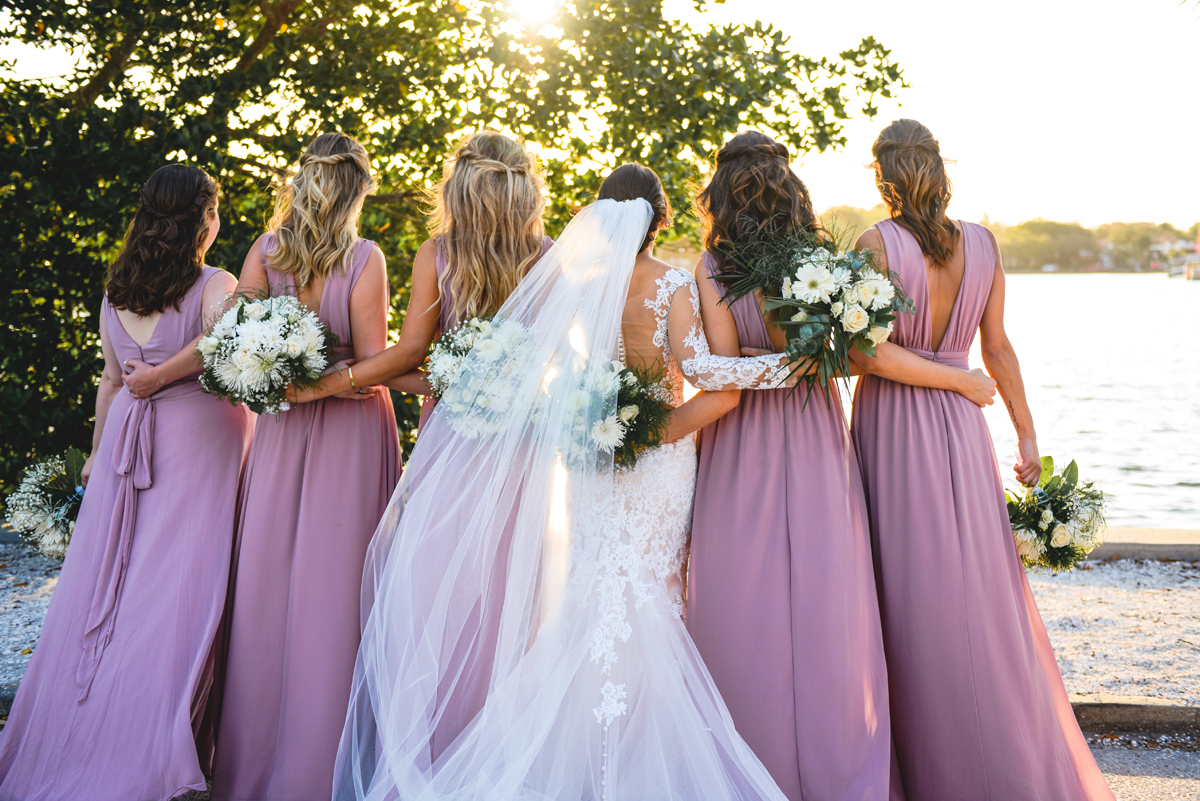 bridesmaids, bride, hugs, sunset, water