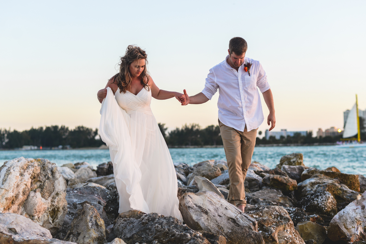 rocks, holding hands, walking, husband, wife, ocean