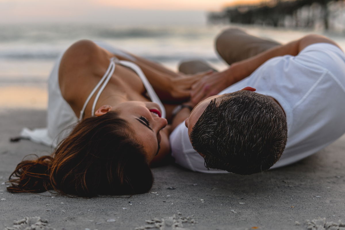 sand, ocean, couple, laying down, sunset, pier