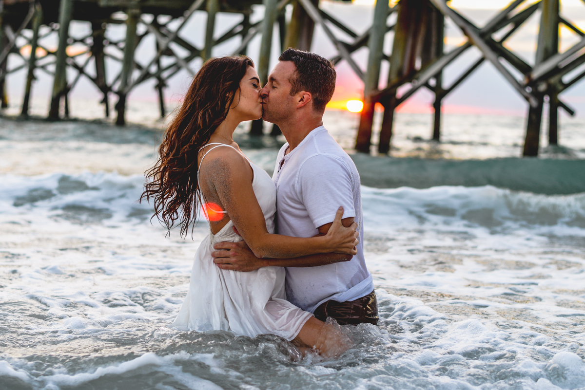 couple, ocean, kissing, sunset, sun flare, pier