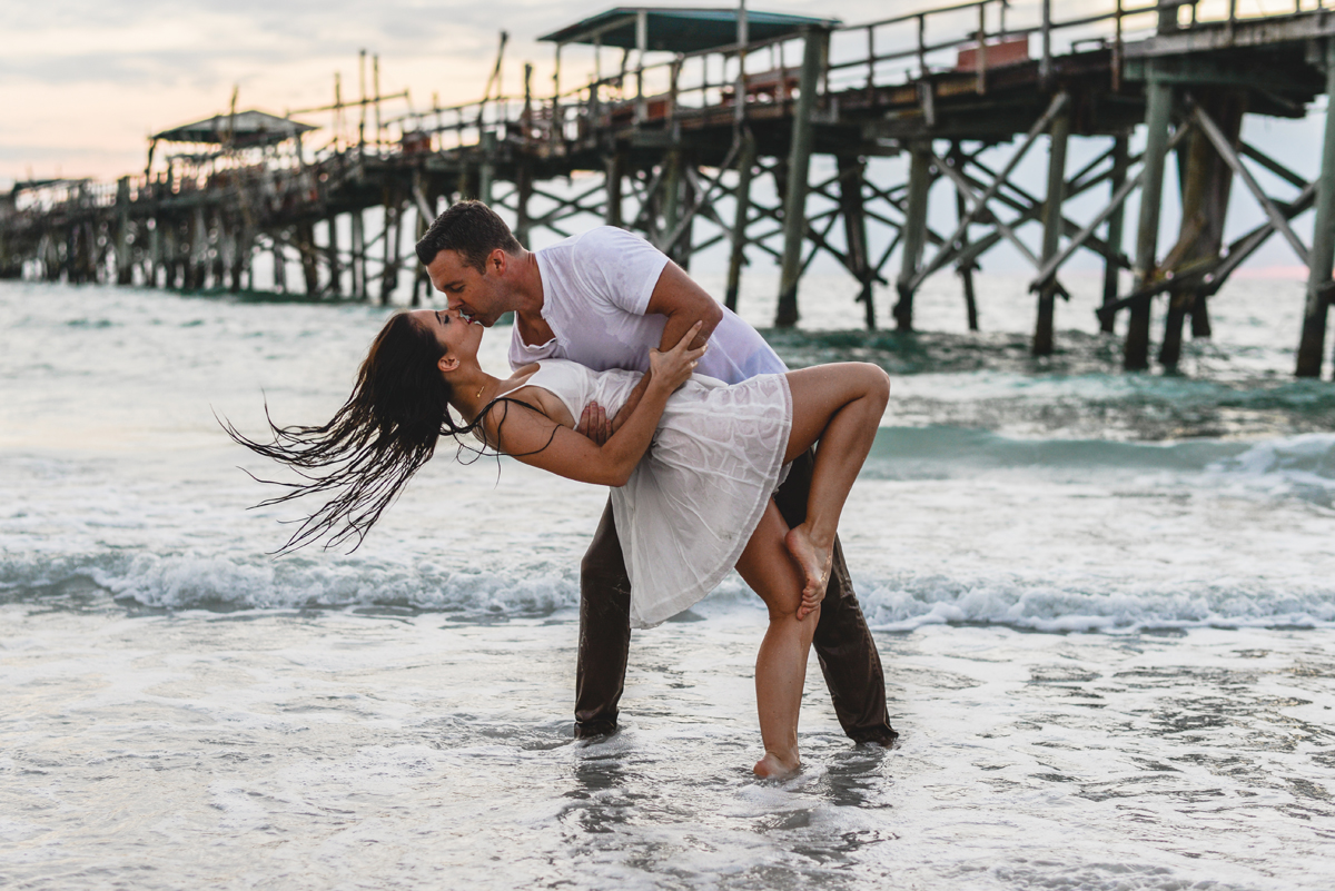 dip, kissing, ocean, waves, pier, sunset, couple