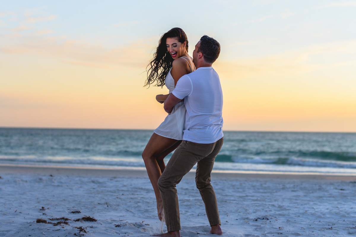 sunset, beach, ocean, couple, laughing, hugging