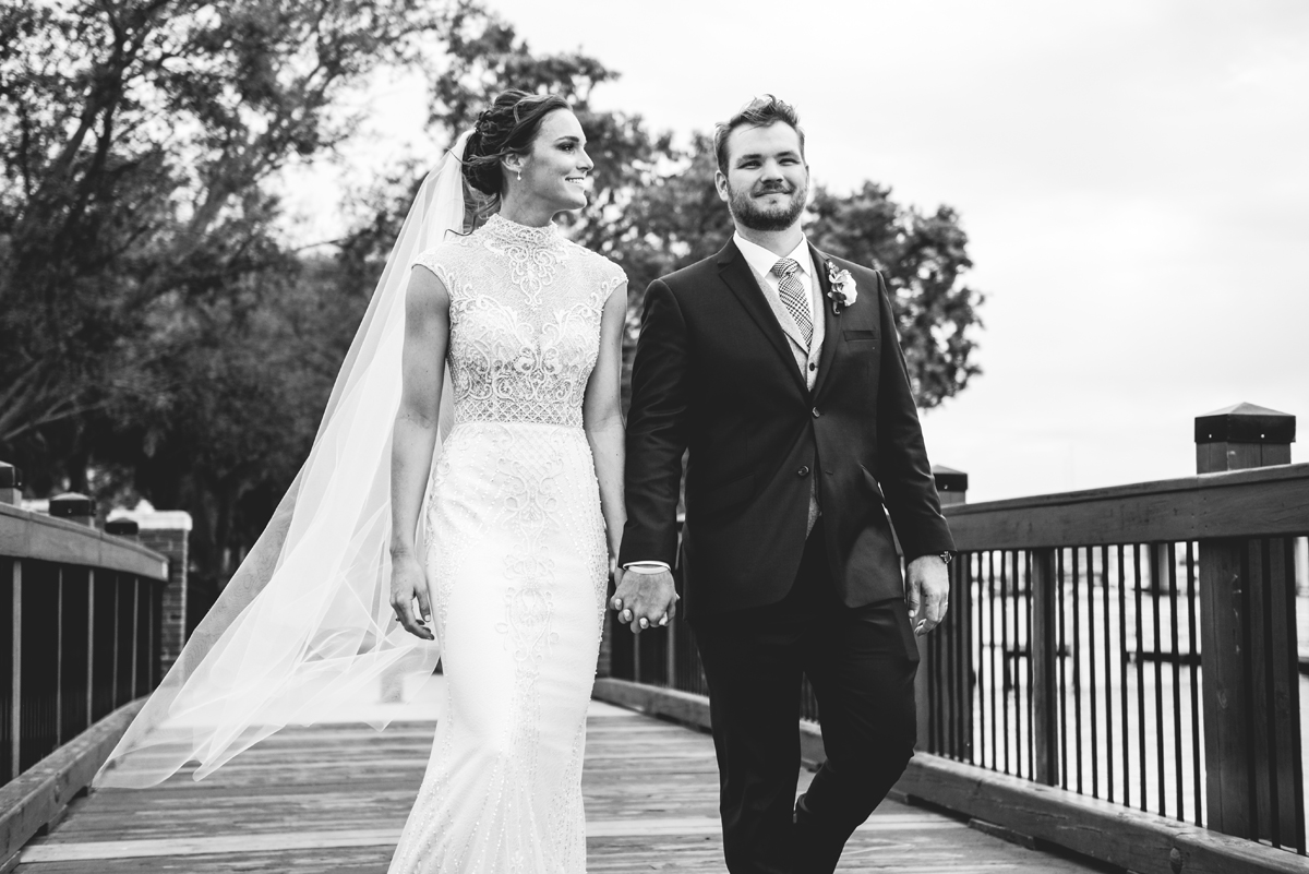 walking, holding hands, bride, groom, dock, water