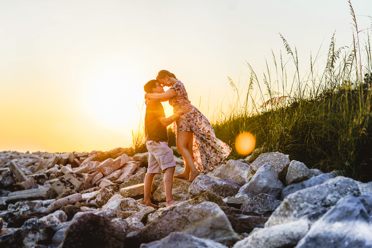 sunset, rocks, beach, sea grass, sun flare 