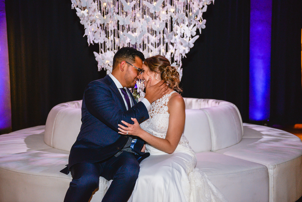 bride, groom, chandelier, butterflies, couch