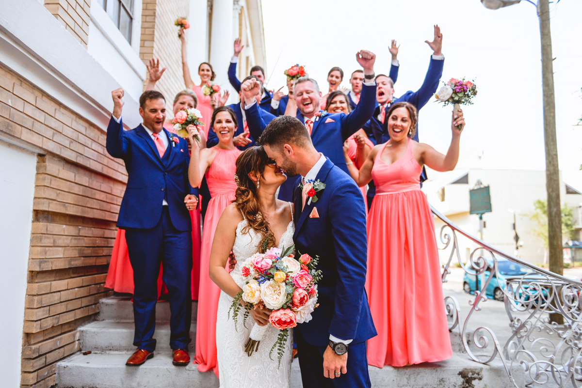 bride, groom, kissing, bridal party, cheering