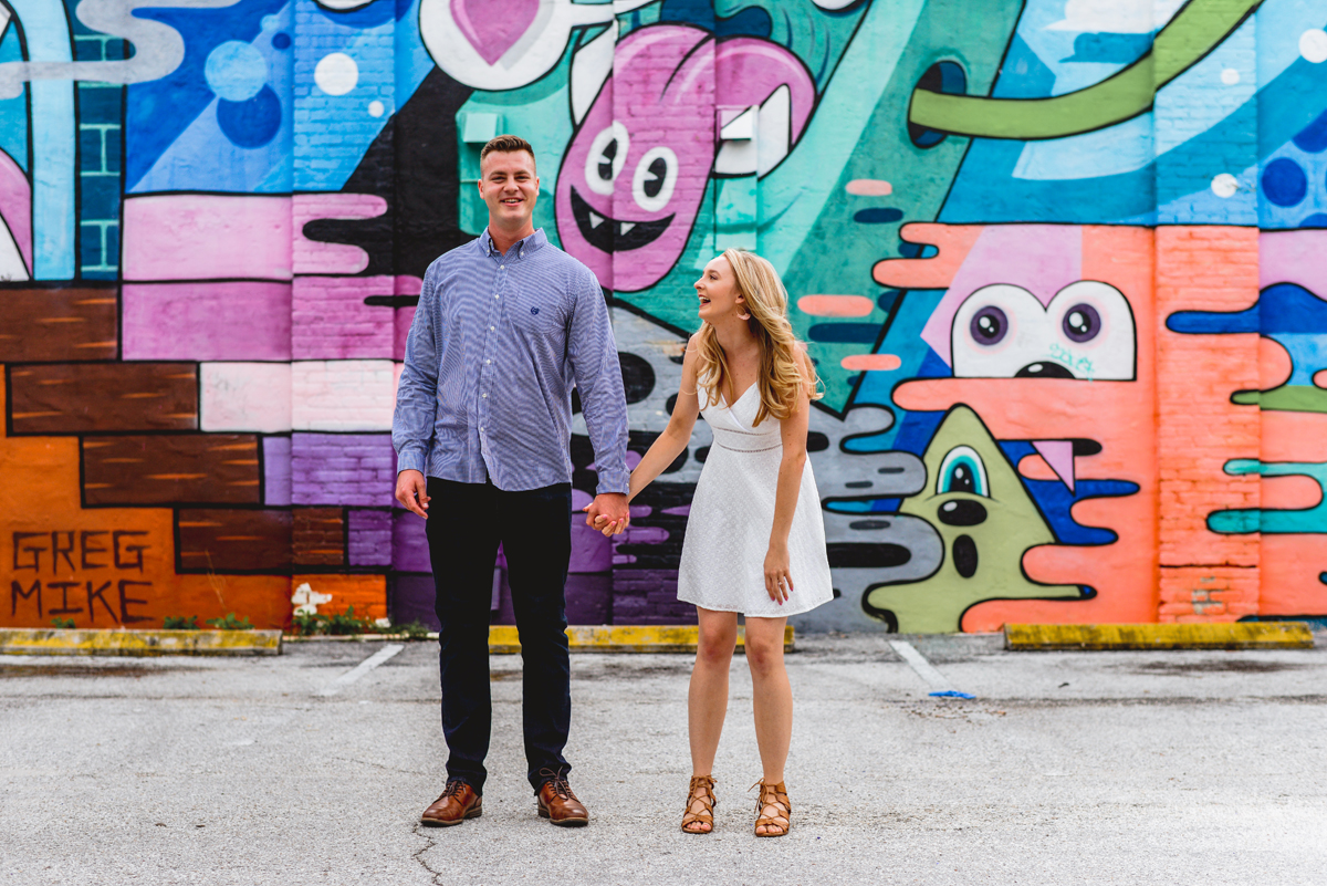 laughing, holding hands, st. Pete, couple, downtown, mural