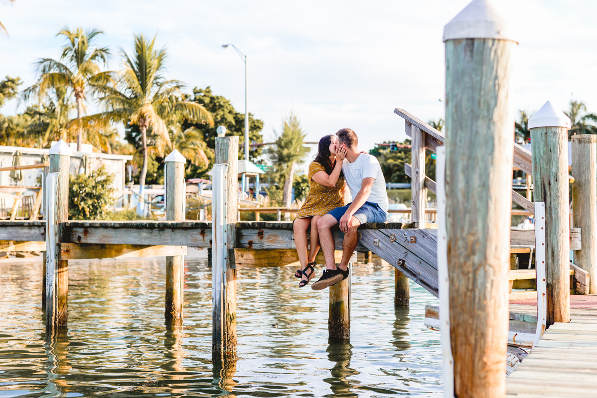 water, beach, dock, couple, sitting, kissing